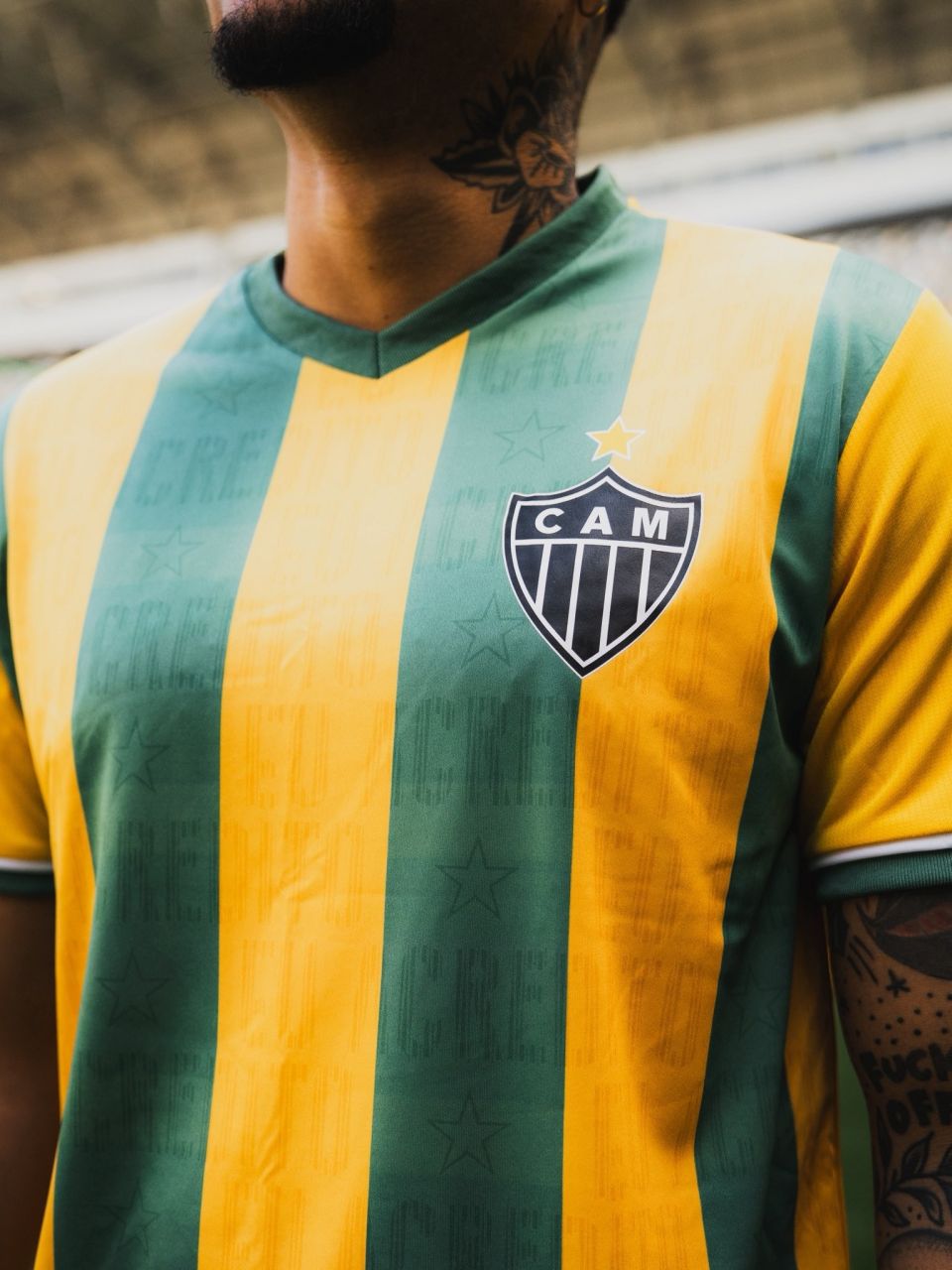 Camisa do Atlético-MG listrada em verde e amarelo com escudo do clube