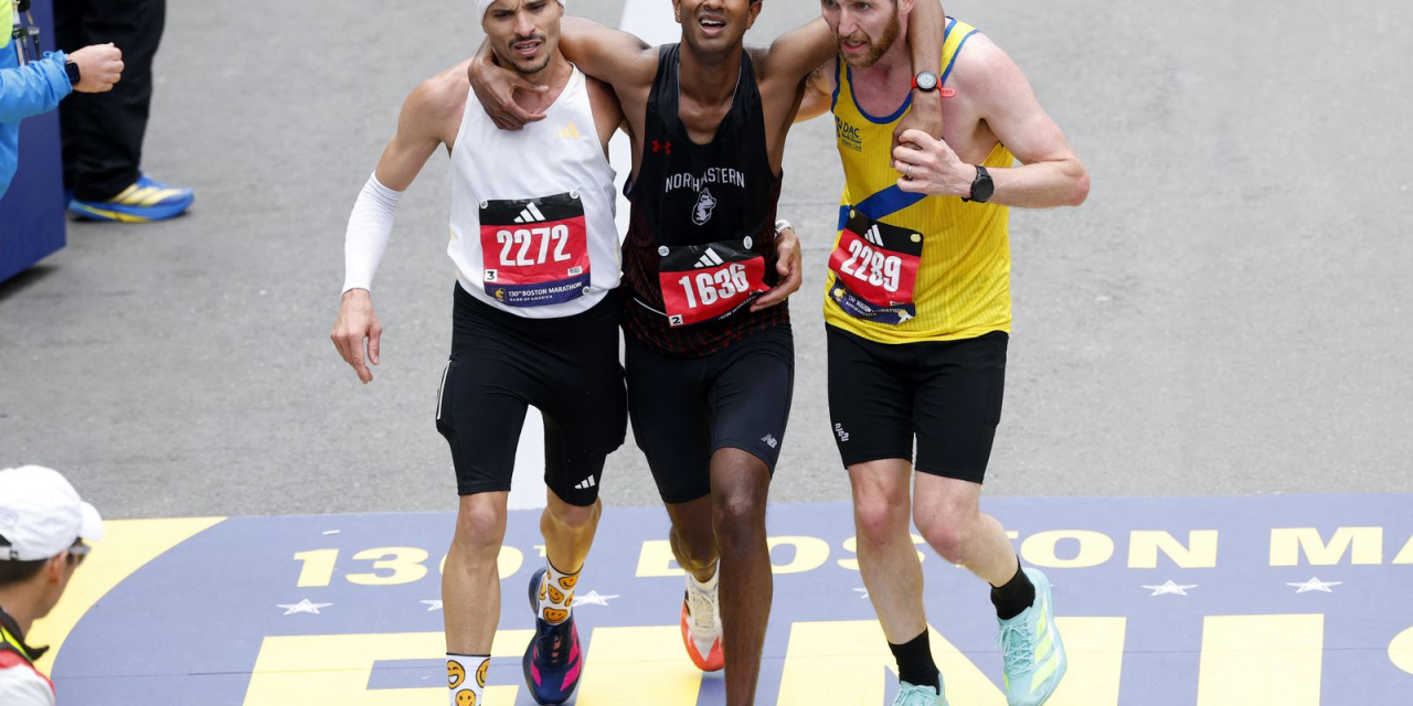 Robson Oliveira ajudando corredor exausto na Maratona de Boston