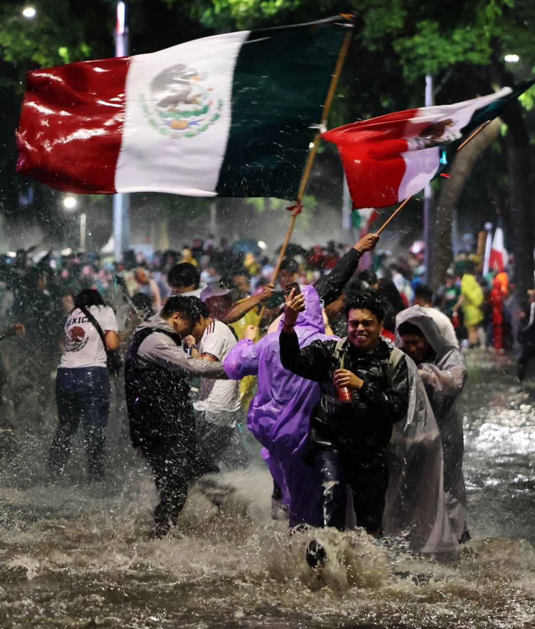 Torcedores mexicanos comemoram na chuva após vitória por 3 a 0