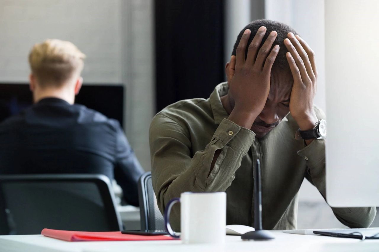 Funcionária consultando mensagem no celular no ambiente de trabalho