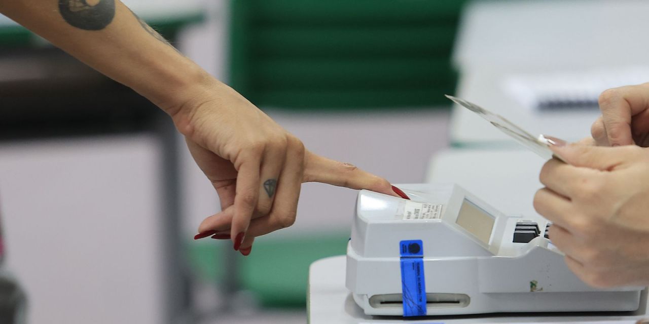 Eleitores sob chuva em local de votação no Rio de Janeiro