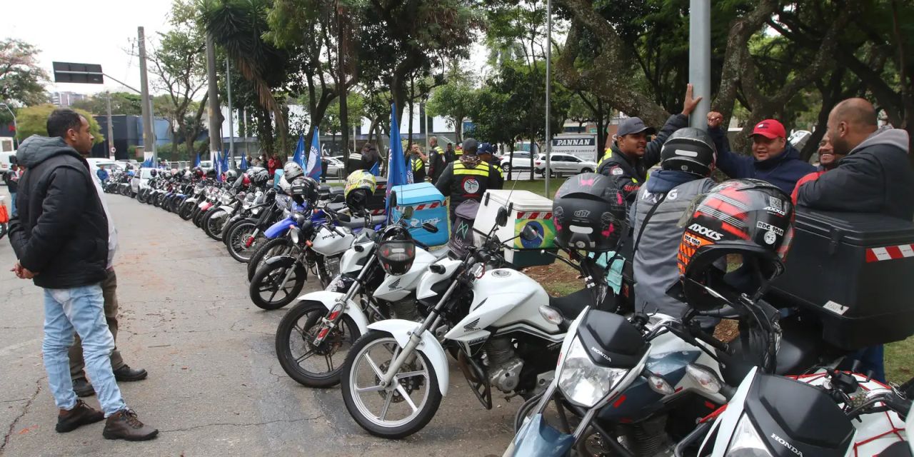 motociclista com celular e motocicleta