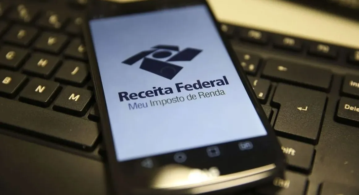 declaração imposto de renda ao lado de maquete de imóvel