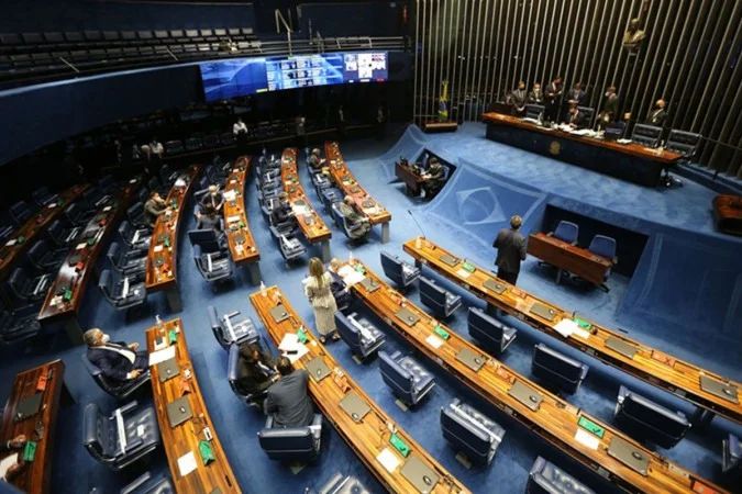 fachada do Congresso Nacional iluminada em roxo