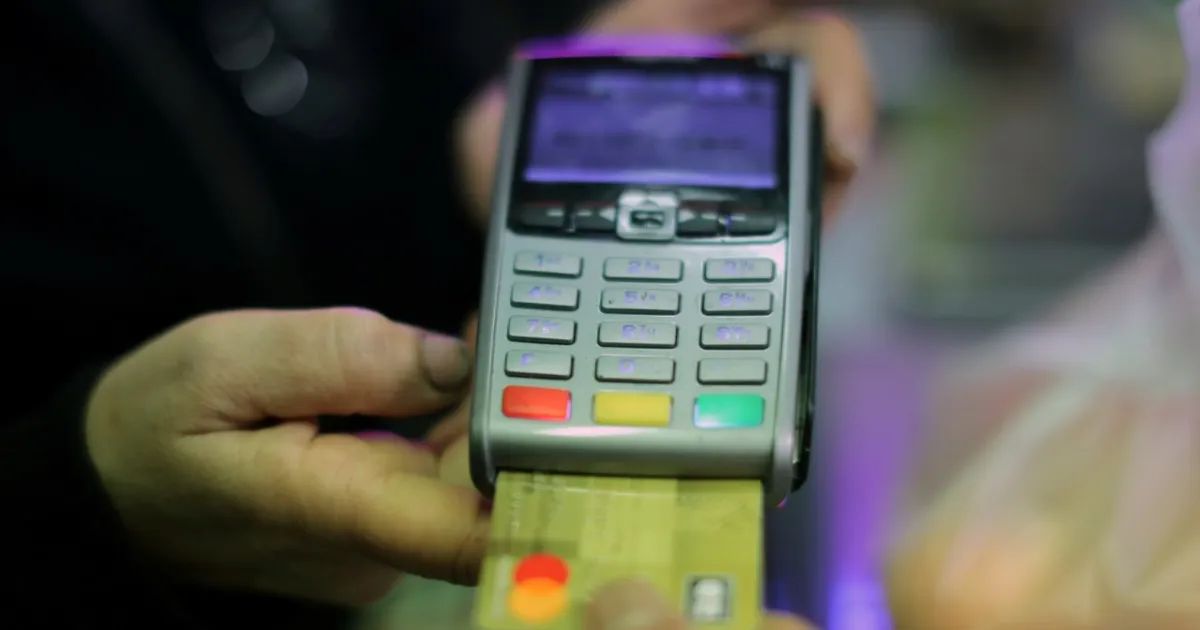 Consumidores em vitrine de loja de roupas