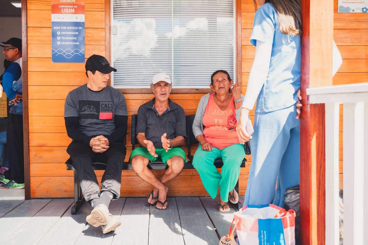 moradores ribeirinhos carregando sacas e colhendo açaí na comunidade do Ubim